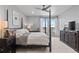 Beautiful primary bedroom featuring a four poster bed and a scenic window view at 2020 Sagerock Dr, Castle Pines, CO 80108
