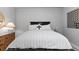 Stylishly decorated bedroom features neutral colors, modern lamps, and a decorative wall hanging at 2020 Sagerock Dr, Castle Pines, CO 80108