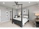 Charming bedroom with a four poster bed, modern artwork, and neutral color palette at 2020 Sagerock Dr, Castle Pines, CO 80108