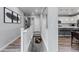 Upstairs hallway with wood floors and neutral-toned walls connecting to the kitchen and living spaces at 2020 Sagerock Dr, Castle Pines, CO 80108