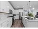 Contemporary kitchen featuring white cabinetry, stainless steel appliances, and stone countertops at 2020 Sagerock Dr, Castle Pines, CO 80108