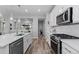 Well-equipped kitchen with stainless steel appliances, white cabinetry, and modern finishes at 2020 Sagerock Dr, Castle Pines, CO 80108