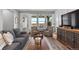 Comfortable living room with large windows, plush seating, and a stylish entertainment center at 2020 Sagerock Dr, Castle Pines, CO 80108