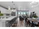 Open-concept living area with a modern kitchen, dining area, and comfortable seating at 2020 Sagerock Dr, Castle Pines, CO 80108