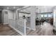 Open-concept living space featuring wood floors, a modern kitchen, and a dining area with natural light at 2020 Sagerock Dr, Castle Pines, CO 80108