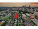 Fantastic aerial view of a tree-lined neighborhood with the city skyline in the background at sunset at 671 Elati St, Denver, CO 80204