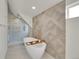 Luxurious bathroom featuring modern tub, separate shower, and elegant tile work at 671 Elati St, Denver, CO 80204