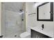 Modern bathroom featuring a glass shower, marble tile, matte black hardware and vanity at 671 Elati St, Denver, CO 80204