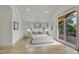 Inviting bedroom boasts modern decor, soft tones, and large windows to a private deck at 671 Elati St, Denver, CO 80204