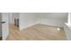 Open bedroom space with light hardwood floors and access to another room at 671 Elati St, Denver, CO 80204