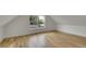 Bright bedroom featuring hardwood floors, a dormer window and white base trim at 671 Elati St, Denver, CO 80204