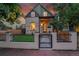 Charming home featuring a gated front yard, manicured landscaping, and stucco exterior at 671 Elati St, Denver, CO 80204