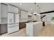 Modern kitchen featuring stainless steel appliances, a center island, and custom cabinetry at 671 Elati St, Denver, CO 80204