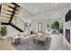 Staged living room featuring a contemporary design, fireplace, and views of the outdoors at 671 Elati St, Denver, CO 80204