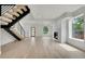 Bright living room with modern staircase, fireplace, and beautiful hardwood floors at 671 Elati St, Denver, CO 80204