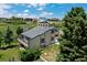 Scenic aerial view of a secluded home featuring mature trees, a fenced yard, and lush greenery at 9163 N Palomino Dr, Castle Rock, CO 80108