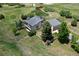 Aerial view of a beautifully landscaped home with spacious yard, mature trees, and fenced perimeter at 9163 N Palomino Dr, Castle Rock, CO 80108