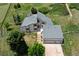 Aerial view of the home, garage, and surrounding green landscape at 9163 N Palomino Dr, Castle Rock, CO 80108