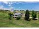 Beautiful landscaped home featuring mature trees, a fenced perimeter, and a spacious yard at 9163 N Palomino Dr, Castle Rock, CO 80108