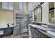 Stylish bathroom showcasing a modern vanity, soaking tub, and glass shower with stone accents at 9163 N Palomino Dr, Castle Rock, CO 80108
