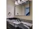 Beautiful bathroom featuring black hardware, stunning stone counters, and a large, rectangular mirror at 9163 N Palomino Dr, Castle Rock, CO 80108