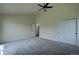 Bright and spacious bedroom featuring plush carpet and ample closet space with double doors at 9163 N Palomino Dr, Castle Rock, CO 80108