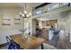 Dining room and kitchen with breakfast bar, stainless appliances and loft access at 9163 N Palomino Dr, Castle Rock, CO 80108