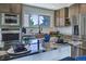 Kitchen island with seating and black marble countertops and stainless appliances at 9163 N Palomino Dr, Castle Rock, CO 80108