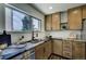 Kitchen detail with stone countertops, tile backsplash and a window view at 9163 N Palomino Dr, Castle Rock, CO 80108