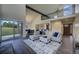Bright and airy living room with vaulted ceilings, a balcony, and access to a large outdoor space at 9163 N Palomino Dr, Castle Rock, CO 80108
