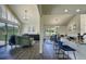 Open-concept living area with soaring ceilings, large windows, and seamless access to the dining and kitchen areas at 9163 N Palomino Dr, Castle Rock, CO 80108
