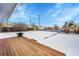 Large backyard with deck and snowy ground at 15235 W 43Rd Ave, Golden, CO 80403