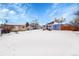 View of a house and shed in a snowy backyard at 15235 W 43Rd Ave, Golden, CO 80403