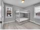 Bright bedroom with a bunk bed, two windows, and light grey walls at 15235 W 43Rd Ave, Golden, CO 80403