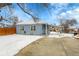 View of the home's exterior and snowy backyard at 15235 W 43Rd Ave, Golden, CO 80403