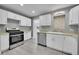 Modern kitchen with white cabinets and stainless steel appliances at 15235 W 43Rd Ave, Golden, CO 80403