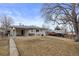 Large grassy backyard featuring a covered patio, perfect for outdoor relaxation and entertainment at 2765 S Winona Ct, Denver, CO 80236