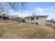 Expansive backyard with a covered patio and mature trees offering shade and privacy at 2765 S Winona Ct, Denver, CO 80236