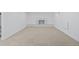 Spacious basement with neutral carpet and a decorative fireplace, providing a versatile living space at 2765 S Winona Ct, Denver, CO 80236