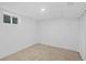 This is a basement space with carpet, white walls, window, and a ceiling light at 2765 S Winona Ct, Denver, CO 80236