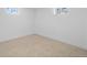 Clean, unfinished basement area with neutral carpet and windows for natural light, ready for customization at 2765 S Winona Ct, Denver, CO 80236