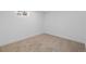 Empty basement with neutral carpet and a small window, offering a blank canvas for customization at 2765 S Winona Ct, Denver, CO 80236