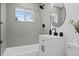 Updated bathroom with gray tile, modern vanity, and black fixtures, offering a sleek design at 2765 S Winona Ct, Denver, CO 80236