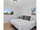 Bright bedroom featuring a comfortable bed with white comforter, plush pillows, and two windows for natural light at 2765 S Winona Ct, Denver, CO 80236