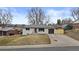 Charming single-story home with a well-kept lawn, attached garage, and inviting entrance at 2765 S Winona Ct, Denver, CO 80236