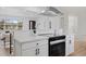 Updated kitchen with white cabinets, quartz countertops, and stainless steel hood vent at 2765 S Winona Ct, Denver, CO 80236