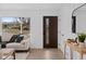 Modern living room featuring a cozy sofa, contemporary decor, and hardwood floors at 2765 S Winona Ct, Denver, CO 80236