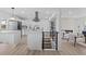 Bright, open-concept living space with modern kitchen and a sleek fireplace at 2765 S Winona Ct, Denver, CO 80236