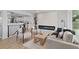 Stylish living room with a modern fireplace, sleek furniture, and hardwood floors at 2765 S Winona Ct, Denver, CO 80236