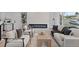 Bright living room featuring modern furniture, a sleek fireplace, and hardwood floors at 2765 S Winona Ct, Denver, CO 80236